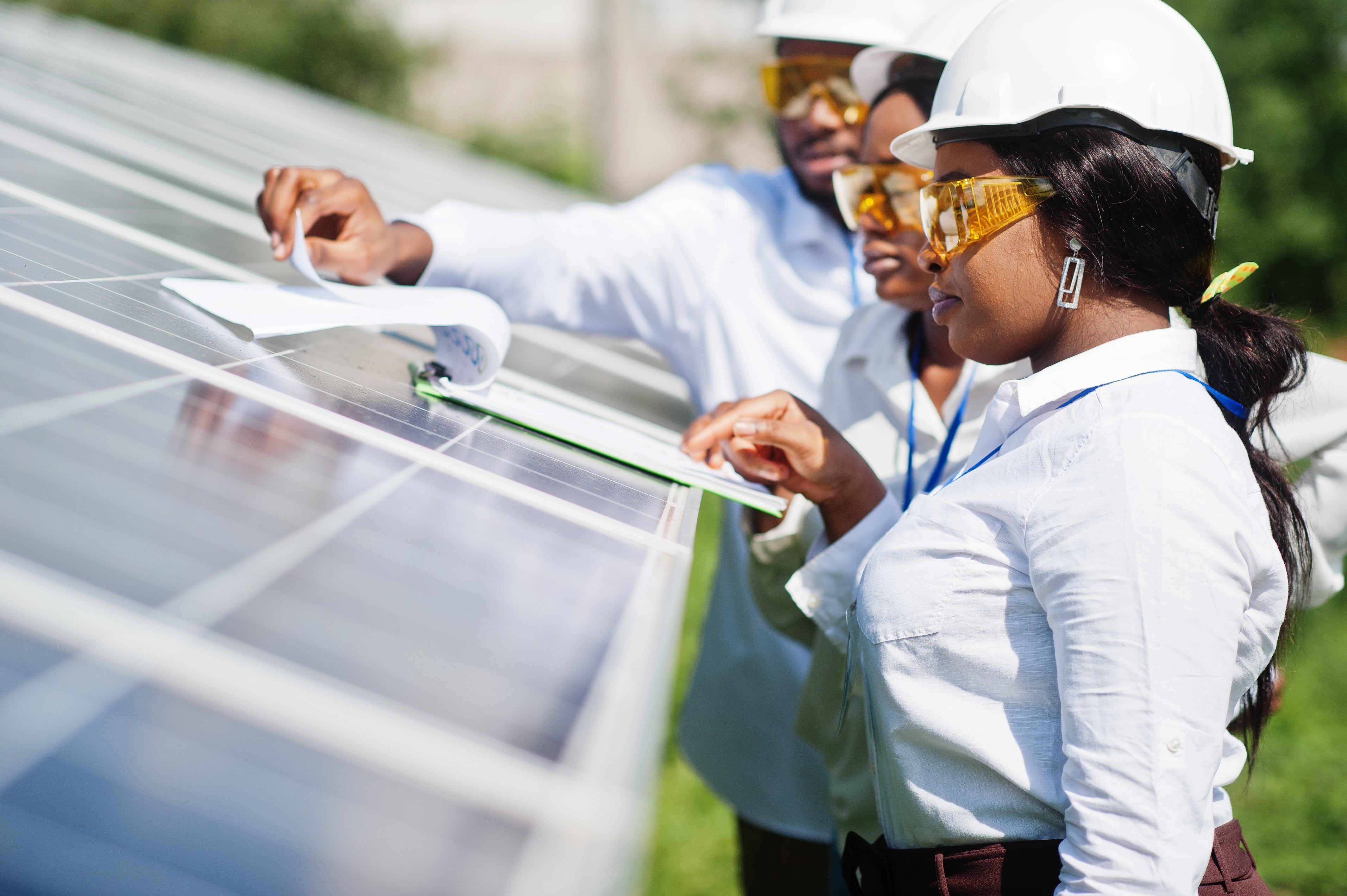 workers inspecting solar panels